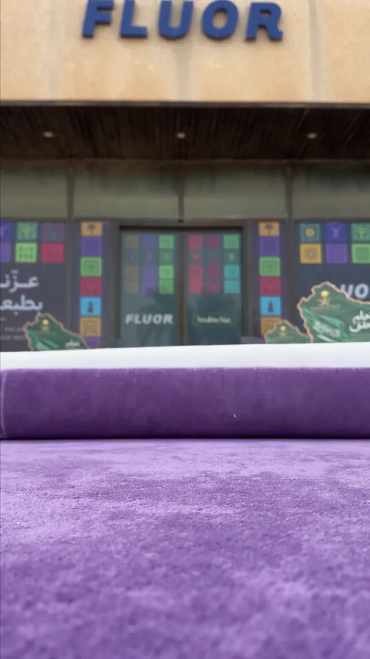 A carpet leading to the entrance of a building dressed for an occasion