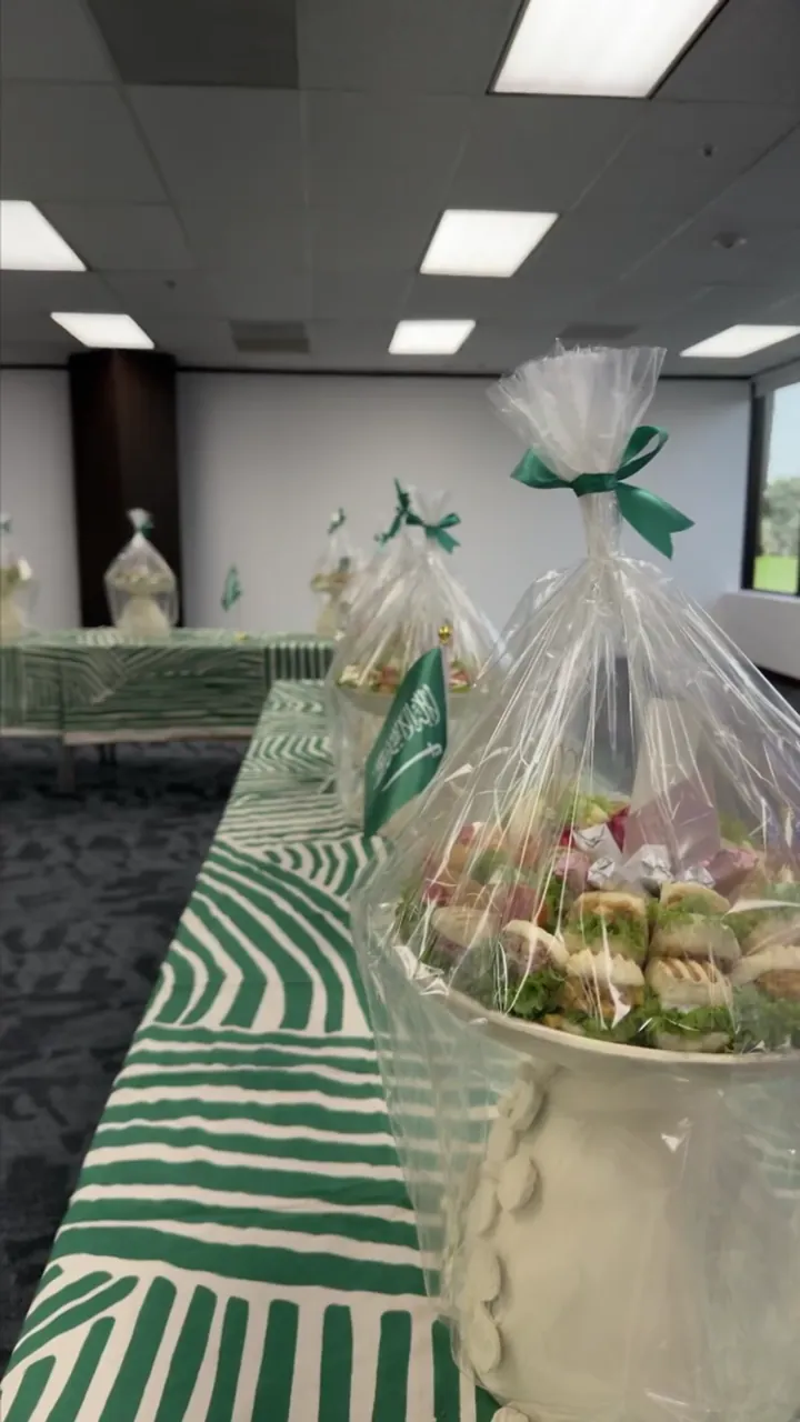 Wrapped gift baskets with green ribbons on a table