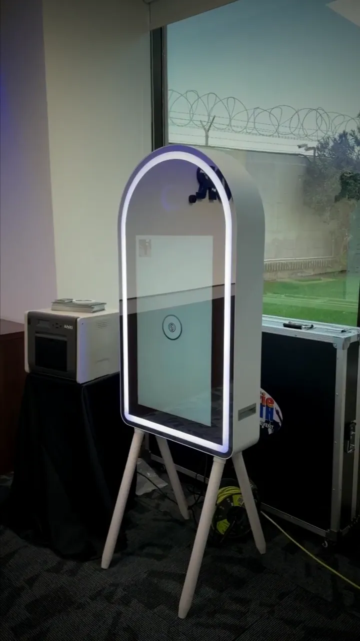 A photo booth with a lit frame in the celebration hall