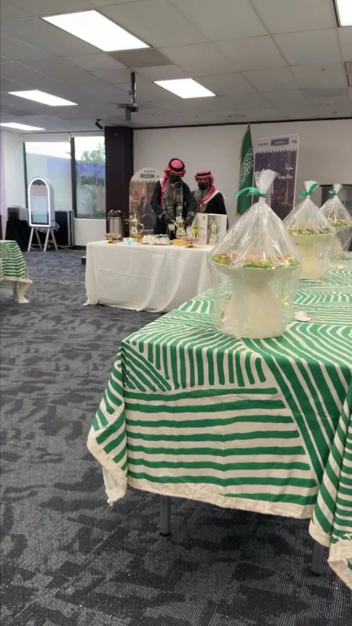 Hospitality tables with green and white cloths in the celebration hall